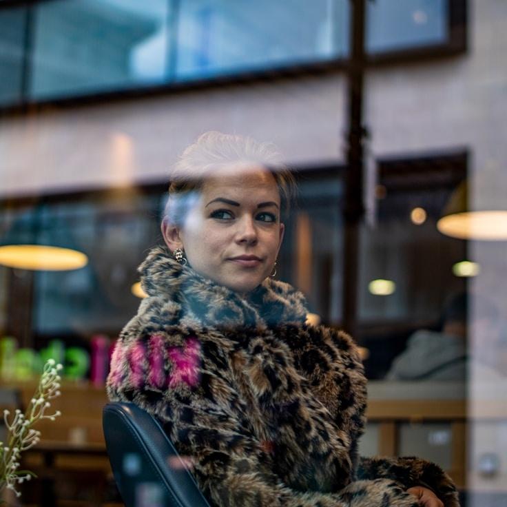 Kaveri Mehta, Lead Design Curator at Calm Garden Plum, reviewing corporate floral arrangements